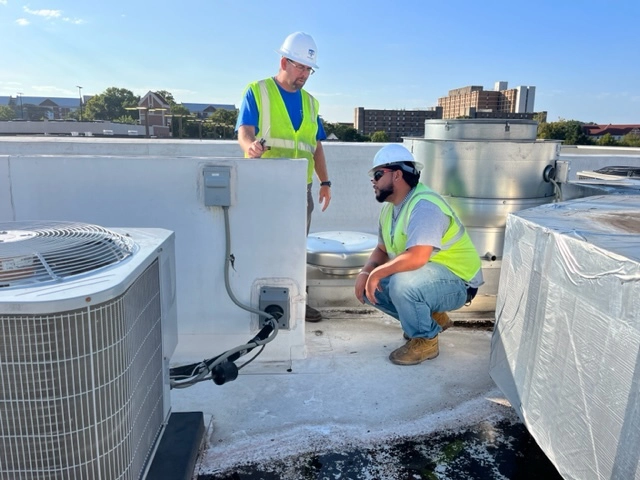 Two Workers Working on a mechanical Unit